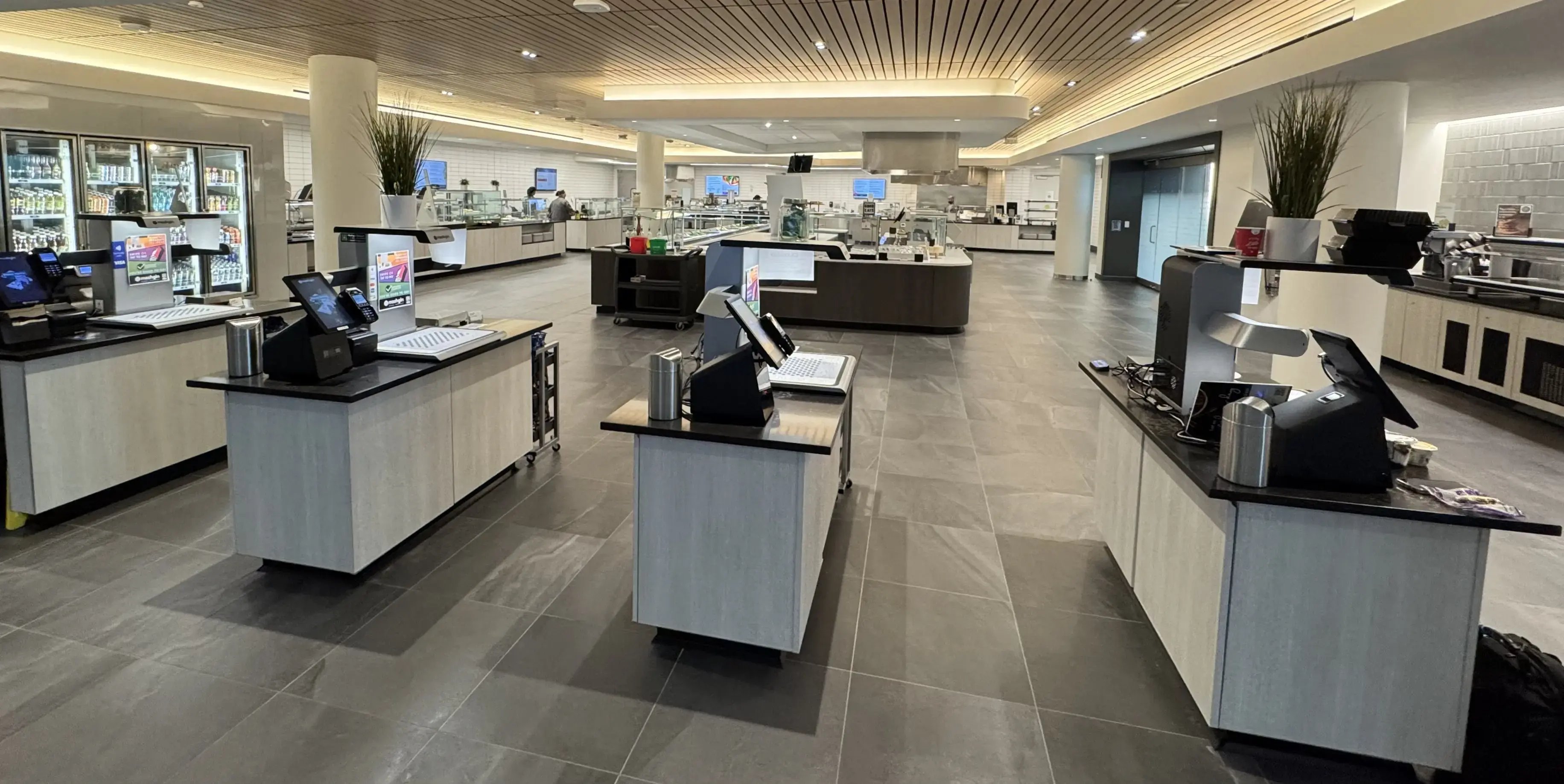 Metric ton of Mashgin checkout kiosks in a business dining setting