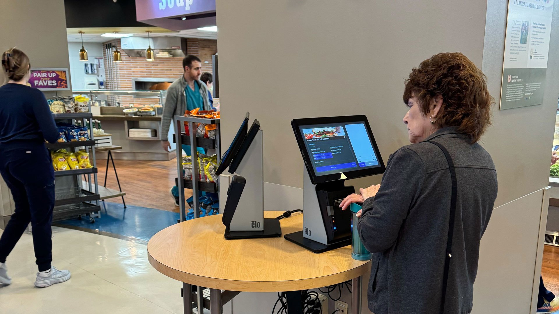 Woman uses a tablet to order a custom meal.